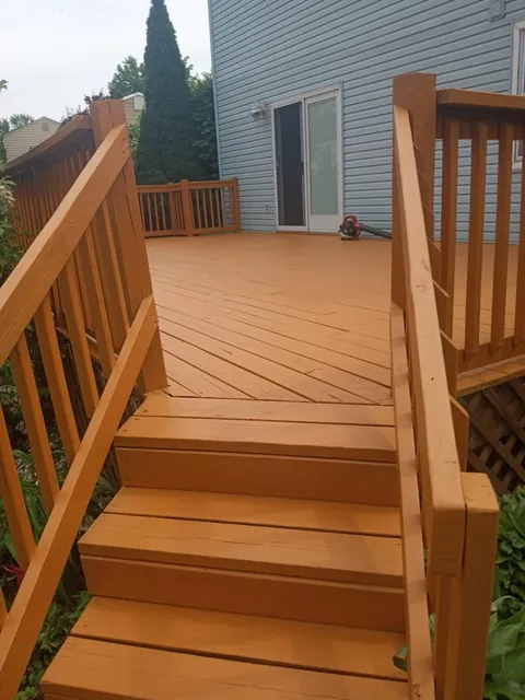 Stained wood deck stairs with new railings
