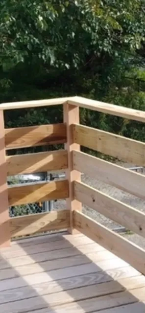 New pressure-treated wood railing on a deck