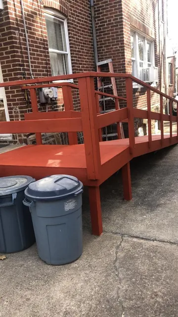 Wheelchair ramp with railings built at a brick home